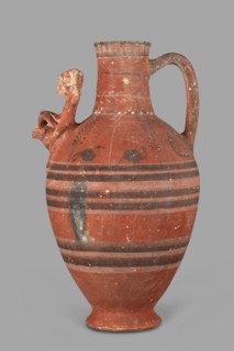 Jug with a figurine of a woman with a jug. Cypriot pottery, female figurines applique. Jug on a