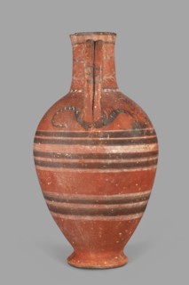 Jug with a figurine of a woman with a jug. Cypriot pottery, female figurine applique. Jug on a foot