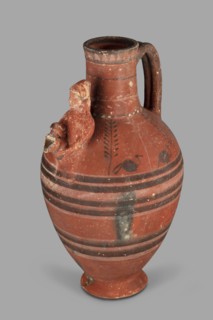 Jug with a figurine of a woman with a jug; Cypriot pottery, female appliqué figurine. Jug on a foot