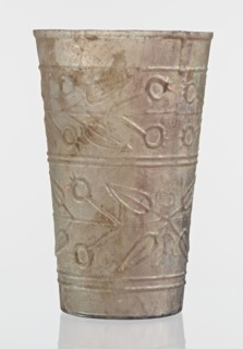 Glass decorated with a leaf and fruit motif;, transparent, colorless glass with relief decoration