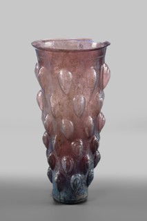 Glass mug; transparent, manganese, iridescent glass. Decorated with 6 rows of convex, stepped