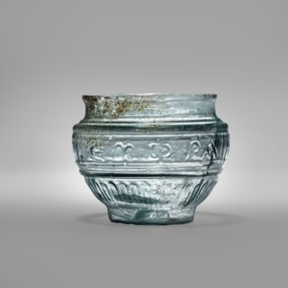 Glass bowl with Greek inscription. Transparent light-blue blown glass in a three-part form,