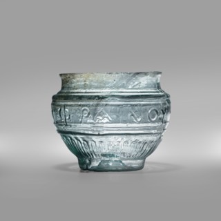 Bowl with Greek inscription. Glass bowl of transparent light blue glass with uneven rim edge,