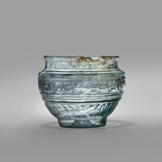 Bowl with Greek inscription. Glass bowl of transparent light blue glass with an uneven rim edge,