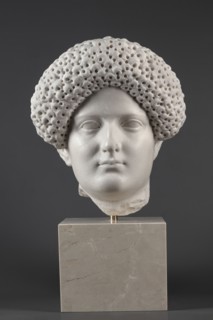 Portrait of a Roman woman, Head with a broad face and an elaborate hairstyle: hair twisted into