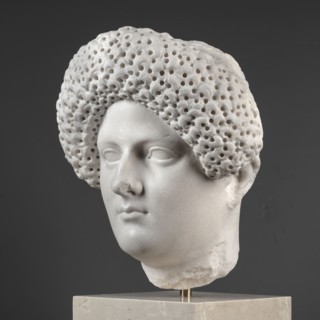Portrait of a Roman woman, Head with a broad, round, full face and a triangular forehead; elaborate