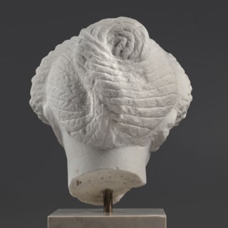 Portrait of a Roman woman, Head with a broad face and an elaborate hairstyle: hair twisted into