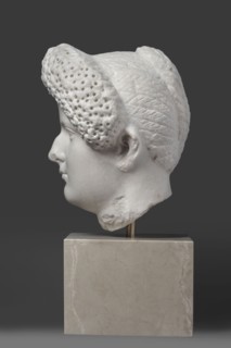 Portrait of a Roman woman, Head with a broad face and an elaborate hairstyle: hair twisted into