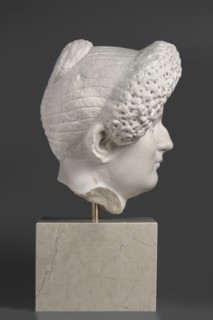 Portrait of a Roman woman, Head with a broad, round full face and a triangular forehead; elaborate