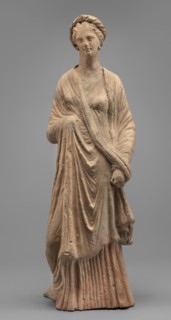 Female Figurine, Standing woman dressed in a long robe, slightly pleated and belted high under the