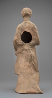 Female Figurine. Standing woman dressed in a long robe, slightly pleated and belted high under the