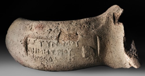 Fragment of a vice from a transport amphora with a stamp depicting the head of Heracles and the