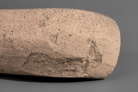 Fragment of a Sinopean amphora vice with a partially preserved rectangular stamp. The stamp is oval