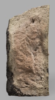 Fragment of a brick with relief decoration. Element of an unglazed panel with a depiction of a bull