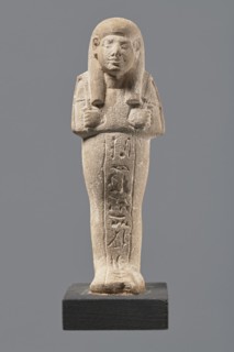 Ushabti, Mummy-shaped figurine made of limestone. Arms crossed on the chest, right folded over
