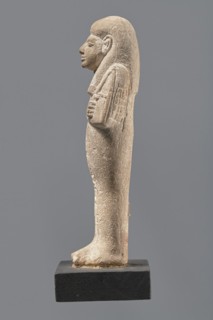 Ushabti, Mummy-shaped figurine made of limestone. Arms crossed on the chest, the right over the