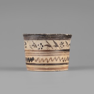 Pyxis with a duck motif. Vessel of yellowish clay with dark brown matte paint and brown varnish;