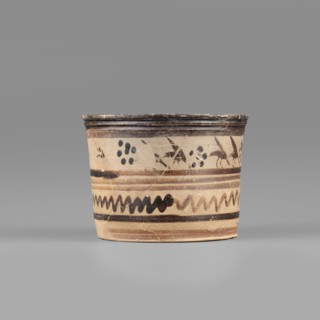 Pyxis with a duck motif. Vessel of yellowish clay covered with dark brown matte varnish; upper band