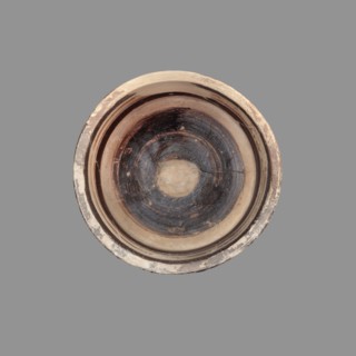 Pyxis with a duck motif. Vessel of yellowish clay with brown matte paint and brown varnish; flat