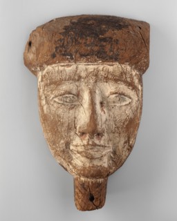 Sarcophagus mask of a deceased man. Creamy, elongated face, almond-shaped eyes, long straight nose.