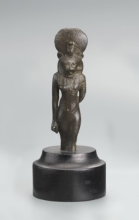 Sekhmet figurine, lion-headed goddess shown standing or walking. The figure has a lioness' head in
