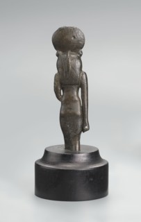 Sekhmet figurine, lion-headed goddess shown standing or walking; lioness head with tripartite wig