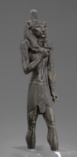Figurine of the god Mahes. Figurine of a striding man with a lion's head. The lion's head is set