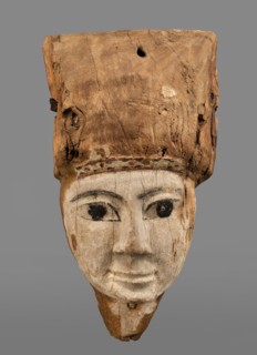 Sarcophagus mask with fragment of a high wig above the forehead, decorated on the edge of the