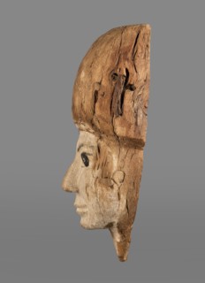 Sarcophagus mask with fragment of a high wig above the forehead, decorated on the edge of the