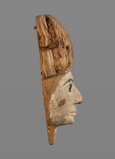 Sarcophagus mask with fragment of a high wig above the forehead, decorated on the edge of the