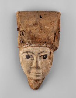 Sarcophagus mask with fragment of a high wig above the forehead, decorated on the edge of the