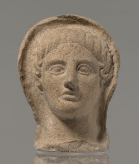 Votive head, Head of a young man covered with a shawl, from under which hair emerges in the form of