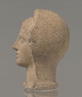 Votive head, Head of a young man covered with a shawl, from under which hair emerges in the form of
