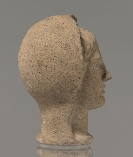 Votive head, Head of a young man covered with a shawl, from under which hair emerges in the form of