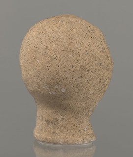 Votive head, Head of a young man covered with a shawl, from under which hair emerges in the form of