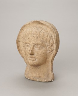 Votive head, Head of a young man covered with a shawl, from under which hair emerges in a fringe