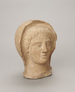 Votive head, Head of a young man covered with a shawl, from under which hair emerges in the form of
