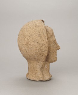 Votive head, head of a young man covered with a shawl, from under which hair emerges in a fringe