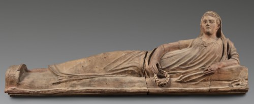 Sarcophagus lid, The deceased is depicted in a semi-reclining position, resting his left forearm on