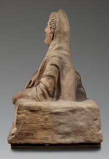 Sarcophagus lid, The deceased is shown in a semi-reclining position, resting his left forearm on a