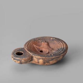 Lamp decorated with a depiction of a dog, unknown eastern workshop, single-burner oil lamp, 1st