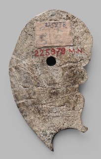 Decoration in the shape of the head of Silenus. Relief appliqué of the head of Silenus. The head is