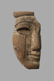 Fragment of a sarcophagus mask. Preserved half of a face made from a single piece of wood. Above
