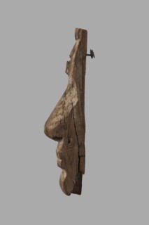 Fragment of a sarcophagus mask. Preserved half of a face made from a single piece of wood. Above