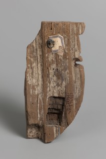 Fragment of a sarcophagus mask. Preserved half of a face made from a single piece of wood. Above