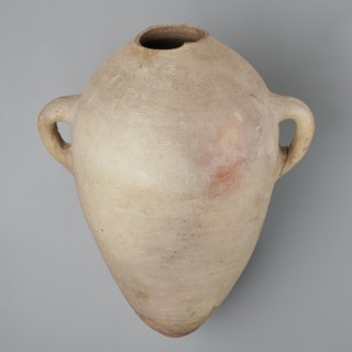 Large amphora with an ovoid shape and a rounded foot. Two small vertical vices placed on the body