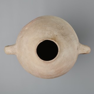 Large amphora with an ovoid shape and a rounded foot. Two small vertical vices placed on the body