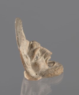 Tragic mask, terracotta, 4th/3rd century BC, Southern Italy. Tragic mask depicting a male face,