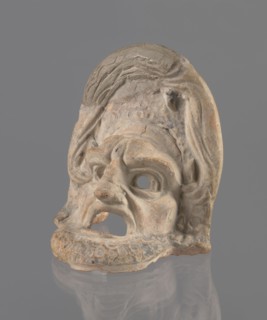 Tragic mask, terracotta, tragic/theater mask. Tragic mask depicting a male face, likely a
