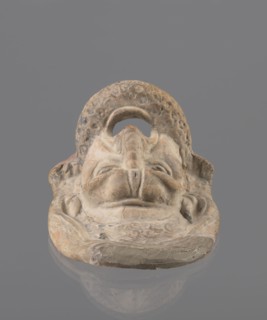 Tragic mask, terracotta, 4th/3rd century BC, Southern Italy. Tragic mask depicting a male face,